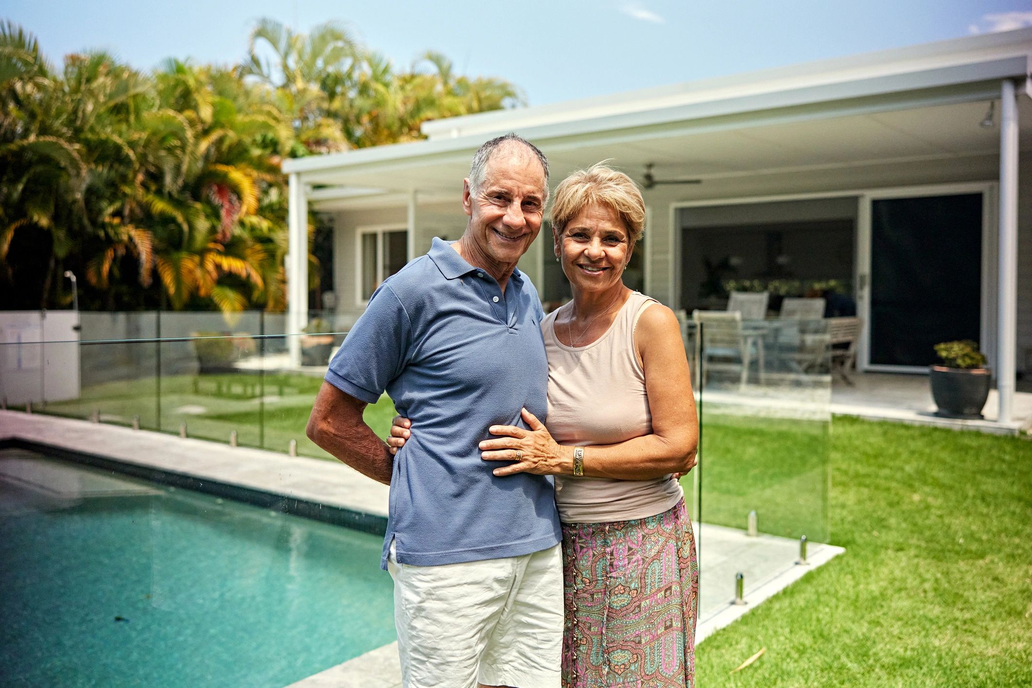 Smiling couple outdoors at their home